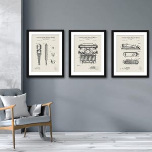 May include: Three black framed prints with white backgrounds and black text. The prints are of vintage patent drawings for a pencil, a typewriter, and a stapler. The text on each print reads "United States Patent Office".