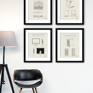 May include: Four black framed prints of vintage computer patent drawings. Each print features a different computer design, including a keyboard, a desktop computer, a monitor, and a tower.