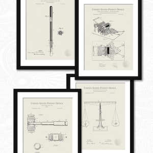 May include: Four black framed prints of vintage patent drawings. The drawings depict a pen, a typewriter, a gavel, and a scale. Each print includes the text "United States Patent Office".