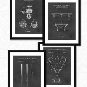 May include: Four black framed prints of vintage patent drawings for billiard equipment. The prints feature a billiard ball, a billiard table, billiard cues, and a billiard ball rack. The prints are on a dark gray background.