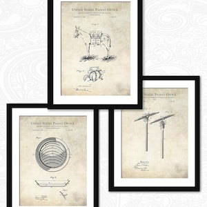 May include: Three framed patent prints. One features a drawing of a donkey with a pack saddle, labeled "PACK SADDLE". Another shows a circular design, and the third depicts a utility pole design. All prints are in black and white.