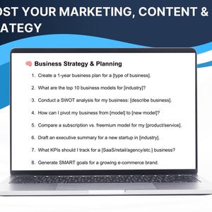 May include: A silver laptop displays a screen with the text "BOOST YOUR MARKETING, CONTENT & STRATEGY." The screen shows a list of business strategy and planning topics, including creating a business plan and conducting a SWOT analysis.