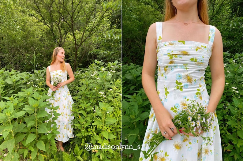 May include: A woman in a white floral dress with a gathered bodice stands in a field of green plants and white flowers. She is holding a bouquet of white flowers in her hand. The text "@madisonlynn_s" is visible in the bottom right corner of the image.