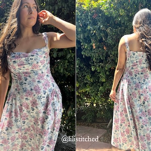 May include: A white dress with a floral print in shades of pink and blue. The dress has a sweetheart neckline and thin straps. The dress is fitted at the bodice and flows out into a skirt.