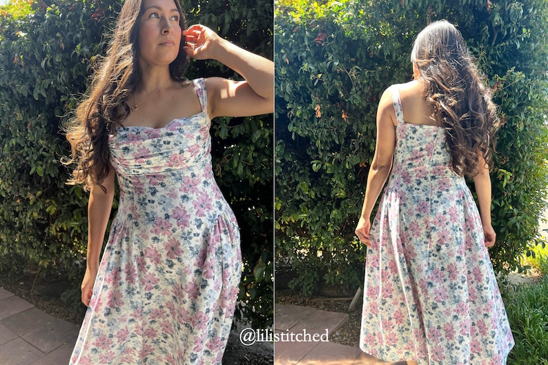 May include: A white dress with a floral print in shades of pink and blue. The dress has a sweetheart neckline and thin straps. The dress is fitted at the bodice and flows out into a skirt.