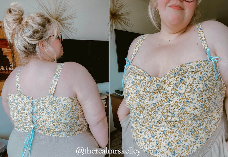 May include: A white and blue floral print top with a sweetheart neckline and adjustable straps. The top has a fitted bodice and a cropped length. The straps are tied at the back with a blue ribbon.