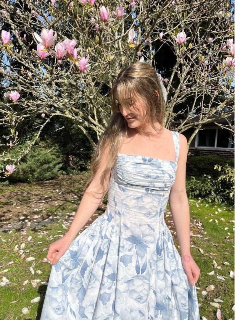 A picture of the Riviera Dress in blue floral. Illustrations fo 3 design options - midi dress, mini dress, and corset top. The sewing pattern comes in sizes 00-36 and includes 6 different design options.