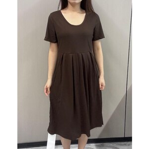 May include: A brown, short-sleeved, midi-length dress with a round neckline and a pleated skirt.