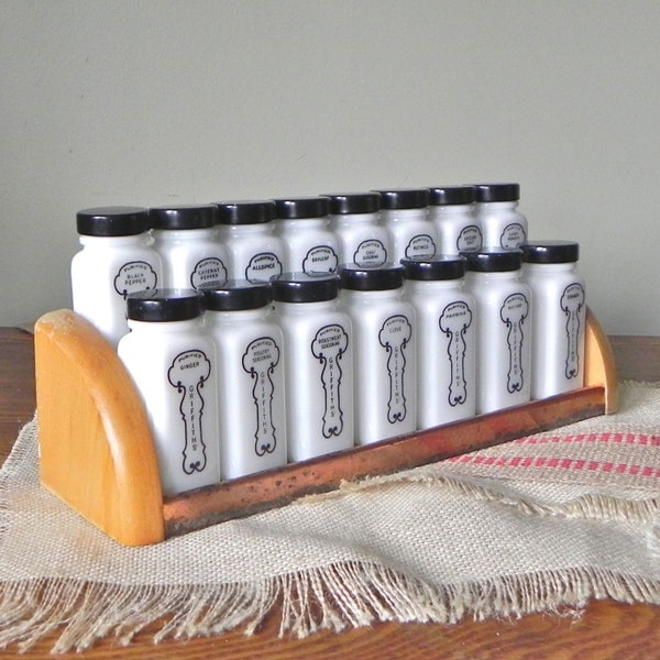 Vintage Griffiths spice rack with milk glass jars black graphics and lids wood and metal rack with copper