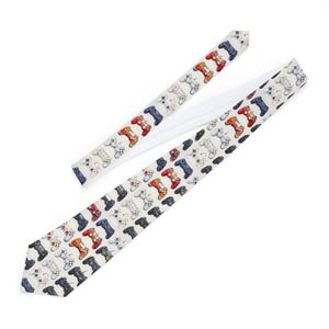 May include: A white and beige tie with a repeating pattern of colorful video game controllers. The tie is made of a smooth, silky fabric.