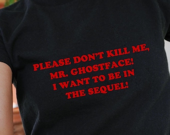 May include: Black t-shirt with red text that reads "PLEASE DON'T KILL ME, MR. GHOSTFACE! I WANT TO BE IN THE SEQUEL!". The shirt's chest measures 34 inches, waist 30 inches, and hips 34 inches. The model is wearing a size S.