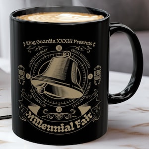 May include: Black ceramic coffee mug with a gold design featuring a bell and the text "King Guardia XXXIII Presents Millennial Fair".