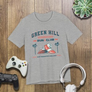 This is a Bella+Canvas 3001 Unisex Jersey Tee with the “Green Hill Run Club Funny Gamer Shirt for 90s Retro Video Game Fans” design on the front of the shirt. Image 3