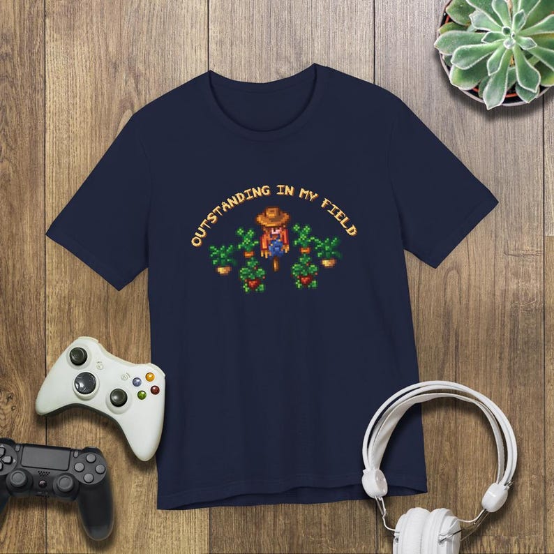 This is a Bella+Canvas 3001 Unisex Jersey Tee with the “Cozy Game Farm Life Shirt Outstanding In My Field Pixel Art for Farming Game Fans” design on the front of the shirt. Image 5