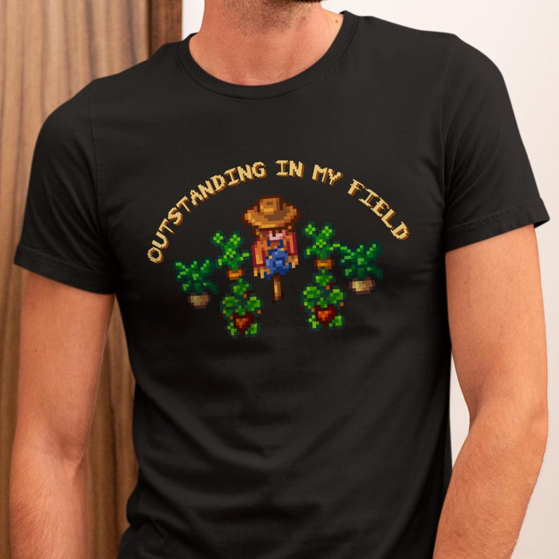 This is a Bella+Canvas 3001 Unisex Jersey Tee with the “Cozy Game Farm Life Shirt Outstanding In My Field Pixel Art for Farming Game Fans” design on the front of the shirt. Image 3