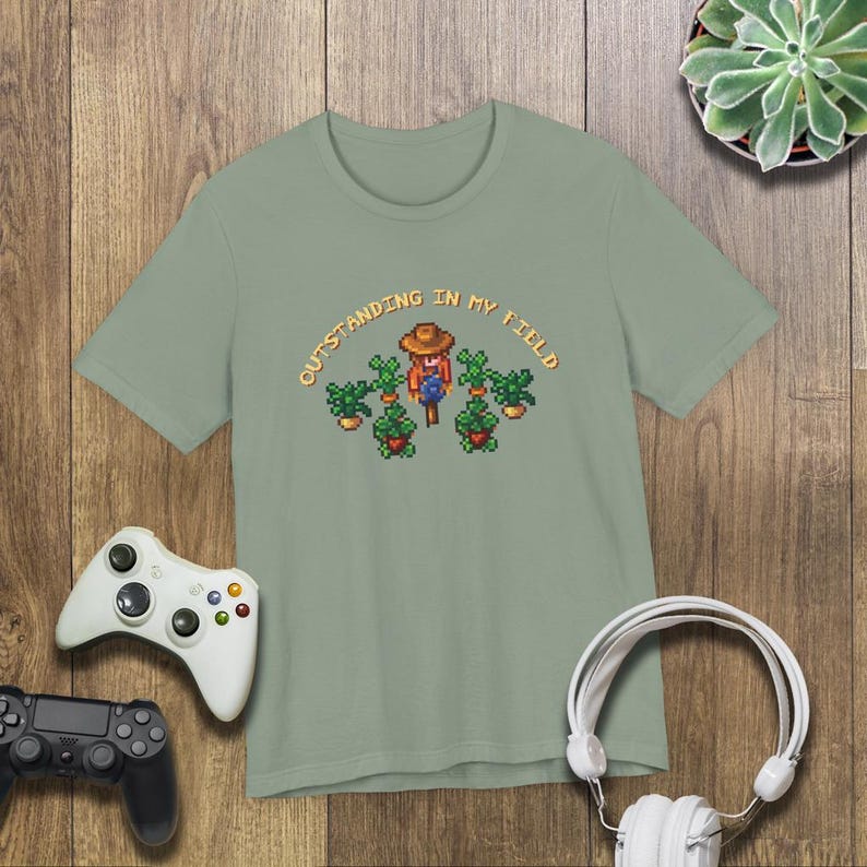 This is a Bella+Canvas 3001 Unisex Jersey Tee with the “Cozy Game Farm Life Shirt Outstanding In My Field Pixel Art for Farming Game Fans” design on the front of the shirt. Image 4