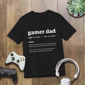 This is a Bella+Canvas 3001 Unisex Jersey Tee with the “Gamer Dad Dictionary Definition Shirt with Funny Quote for Fathers Who Play Video Games” design on the front of the shirt. Image 2