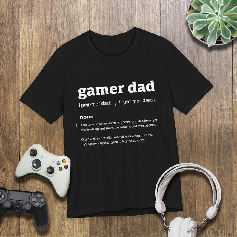 This is a Bella+Canvas 3001 Unisex Jersey Tee with the “Gamer Dad Dictionary Definition Shirt with Funny Quote for Fathers Who Play Video Games” design on the front of the shirt. Image 2