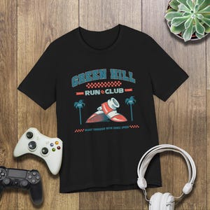 This is a Bella+Canvas 3001 Unisex Jersey Tee with the “Green Hill Run Club Funny Gamer Shirt for 90s Retro Video Game Fans” design on the front of the shirt. Image 5