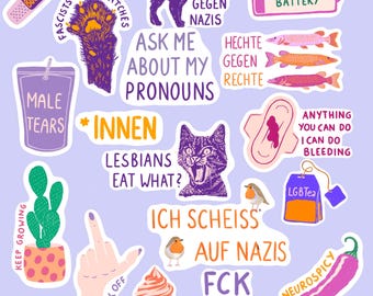 May include: A collection of colorful stickers with various designs and text. The stickers feature illustrations of a cat, a cactus, a cupcake, and a hand giving the middle finger. Text includes phrases like "Ask Me About My Pronouns" and "Lesbians Eat What?"