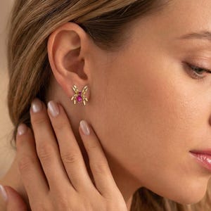 May include: A white ceramic mug with a black handle and the text "But First, Coffee" in a black, bold font. The mug is on a white surface. The mug is 4 inches tall.