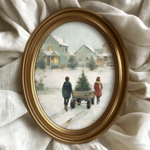 May include: An oval, gold-framed painting depicts a winter scene with two figures pulling a cart with a Christmas tree through the snow. Houses with lit windows are in the background. The painting is set against a white, textured fabric.