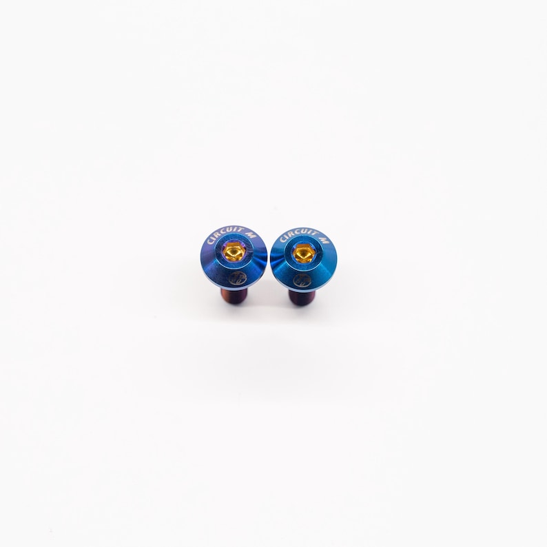 May include: Two blue and gold metal screws with the text "CIRCUIT M4" on the top.