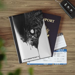 May include: Black and white passport cover featuring a graphic of a creature with sharp teeth and dripping liquid. The cover has the word "PASSPORT" printed on it.