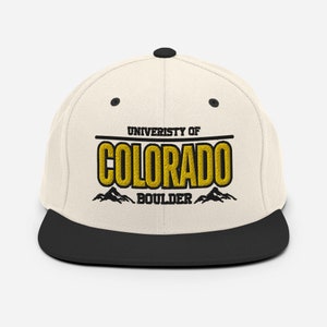 May include: A white and black baseball cap with the text "University of Colorado Boulder" in yellow and black lettering.