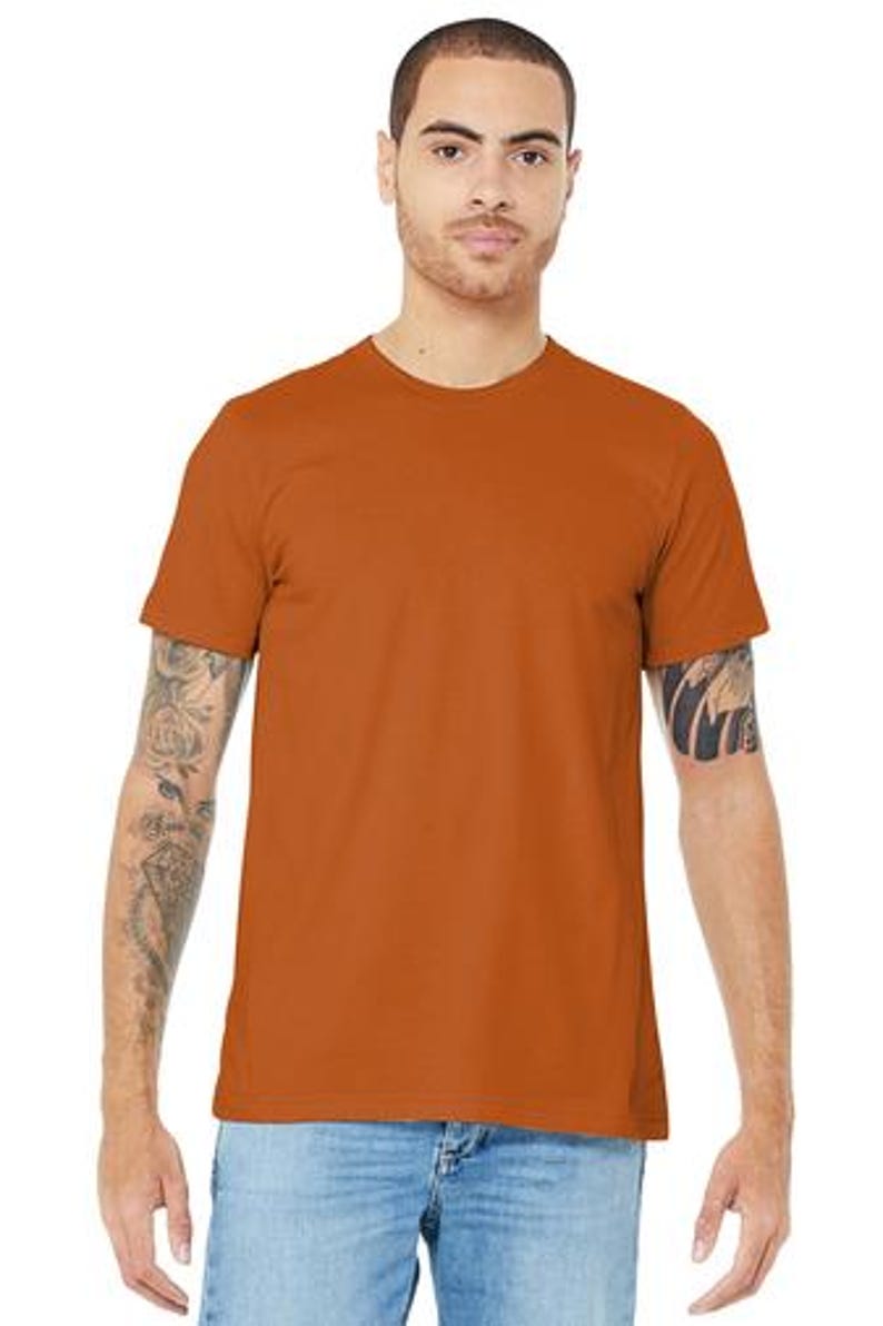 May include: A rust-colored short-sleeved t-shirt with a crew neck.