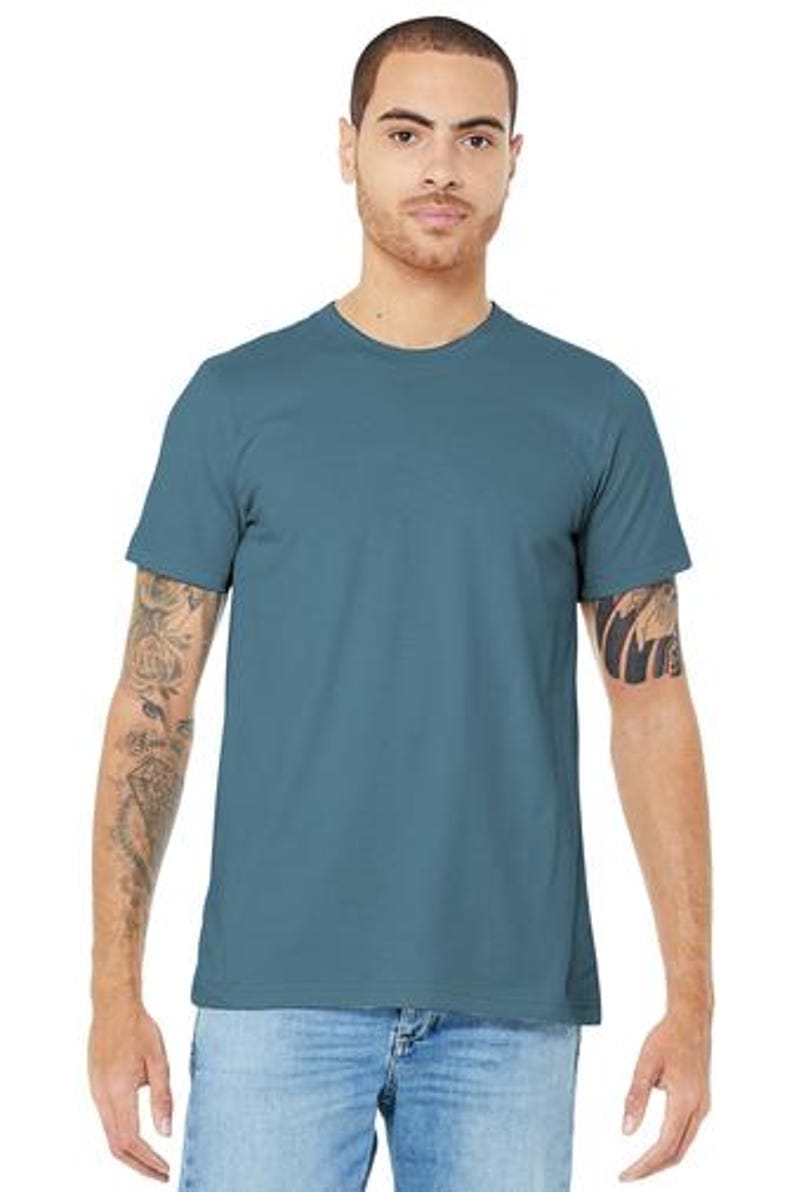 May include: A plain, light blue t-shirt with short sleeves. The t-shirt is made of a soft, comfortable fabric.