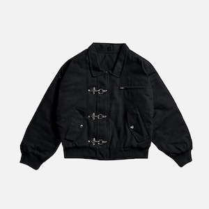 May include: Black jacket with a collar, three silver clasps, and a zippered chest pocket. The jacket has long sleeves and a ribbed hem. The jacket is a solid black color.