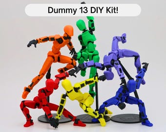 May include: A set of six articulated action figures in various colors, including red, orange, yellow, green, blue, and purple. The figures are posed in different dynamic positions and are labeled "Dummy 13 DIY Kit!"
