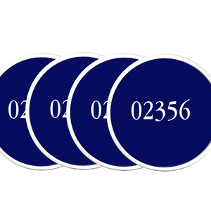 May include: Four round blue coasters with white numbers. The numbers on three coasters are "02" and the number on the fourth coaster is "02356".