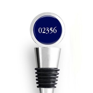 May include: A silver bottle stopper with a blue round top featuring the number "02356" in white.