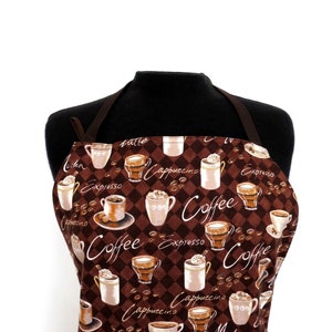 Puede incluir: Un delantal marrón con un patrón a cuadros y un tema de café. El delantal está decorado con varias tazas de café, granos de café y la palabra "Café" en una fuente estilizada.