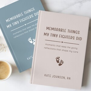 May include: Two hardcover journals with the text "MEMORABLE THINGS MY TINY FIGHTERS DID". One journal is light blue, the other is beige. Each journal has a heart and footprint graphic. The journals are for recording memories.