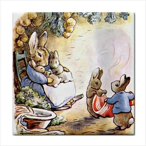 May include: A decorative ceramic tile featuring a classic watercolor illustration of a mother rabbit in a blue dress holding two small bunnies, while two other rabbits stand nearby, one wearing a blue jacket and holding a red and white striped cloth.