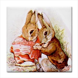 May include: A square decorative tile featuring a watercolor illustration of two brown rabbits. One rabbit wears a red patterned garment, while the other wears a brown jacket. The rabbits are positioned close together against a light background.