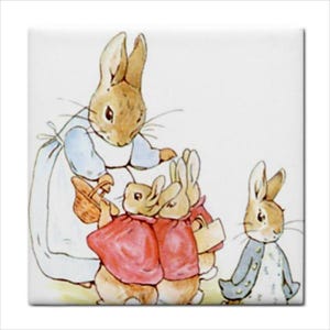 May include: A square ceramic tile featuring a watercolor illustration of a mother rabbit in a blue dress and white apron holding a basket, surrounded by three small rabbits in red jackets and one rabbit in a blue jacket on a plain white background.