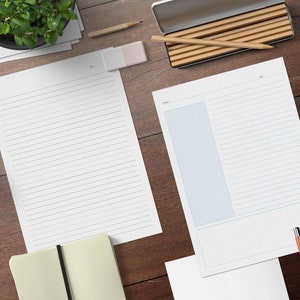 May include: Overhead shot of a wooden desk with stationery. Two white lined papers, one with a blue border, are on the desk. A pencil, eraser, and a pencil case are also visible. A small plant and a notebook are also on the desk.