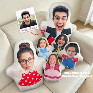 May include: Custom photo pillows in various designs, including a woman in a red polka dot dress, a man in a suit, and a princess. The pillows are personalized with faces and are on a white couch. The image also includes a photo with the text "Your Photo".