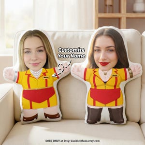May include: Two custom-designed pillows shaped like people, each with a face and a yellow uniform with a red apron. The text "Customize Your Name" is above the pillows. The pillows are on a beige couch.