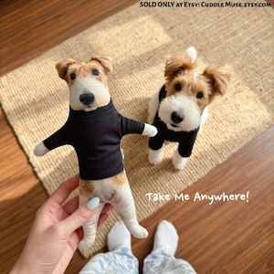May include: A plush toy shaped like a wire fox terrier wearing a black sweater, held next to a real wire fox terrier wearing a matching black sweater. The text reads: SOLD ONLY AT ETSY: CUDDLE MUSE.ETSY.COM and Take Me Anywhere!