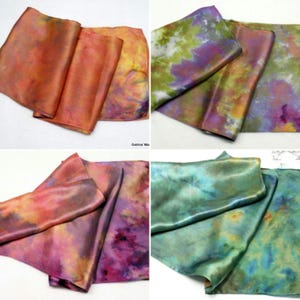 Könnte beinhalten: Vier Seidenschals mit Batik-Mustern in Orange-, Lila-, Grün- und Blautönen. Die Schals sind gefaltet und in einem Raster angeordnet.