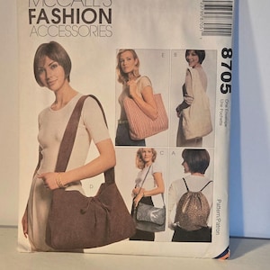 May include: McCall's Fashion Accessories pattern 8705 for a one-envelope tote bag with a drawstring closure. The pattern includes instructions for making four different styles of bags, including a tote bag, a shoulder bag, a crossbody bag, and a backpack.