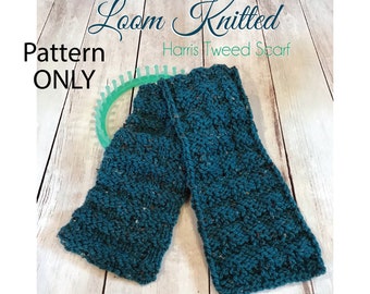 May include: A teal blue loom knit scarf with a textured pattern. The scarf is laid out on a light wood surface with a green loom in the background. The text "Loom Knitted Harris Tweed Scarf" is visible in the image.