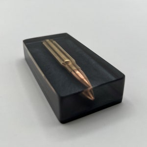 Handcrafted using Once- Fired .308 Brass Casing w/ Projectile Embedded in Epoxy- Unique Paperweight w/ Ronin Black Mica Powder Base