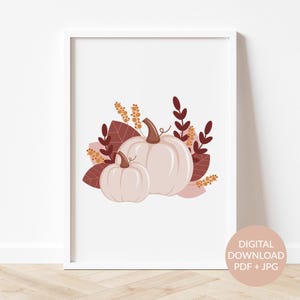 May include: A digital print featuring two white pumpkins with brown stems, surrounded by brown and orange leaves. The pumpkins are arranged in a cluster, with the larger pumpkin in the back and the smaller pumpkin in the front. The leaves are arranged around the pumpkins, creating a fall-themed design.