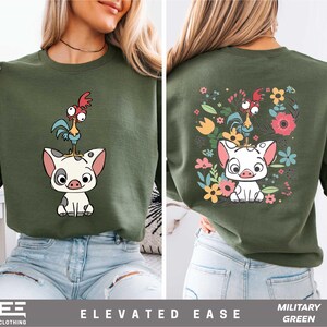 a woman wearing a green shirt with an image of a pig on it
